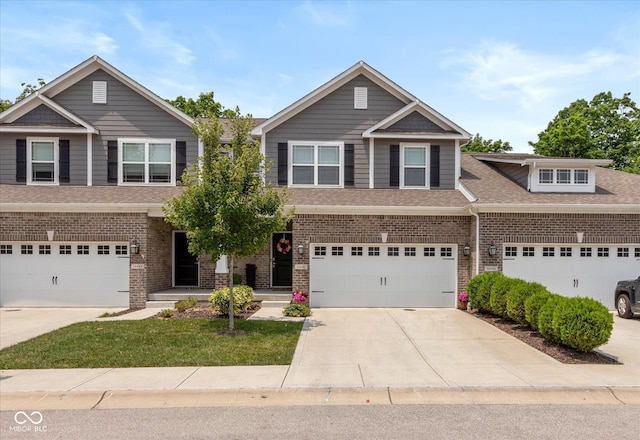 14442 Treasure Creek Ln, Fishers, IN 46038 - view of front facade with driveway, brick siding, roof with shingles, and an attached garage