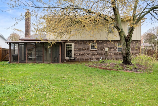 8306 Corkwood Dr, Indianapolis, IN 46227 - back of house featuring a sunroom, brick siding, and a chimney