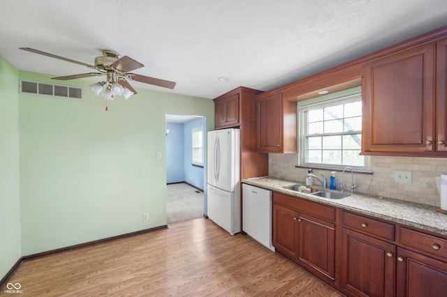 8306 Corkwood Dr, Indianapolis, IN 46227 - kitchen featuring white appliances, light wood-style flooring, backsplash, and ceiling fan
