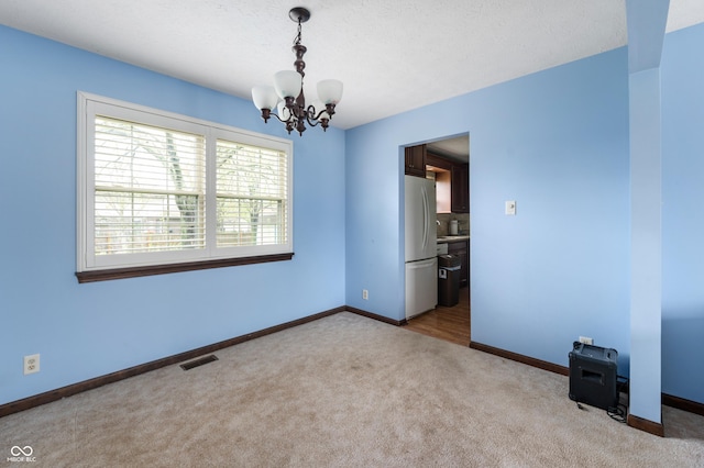 8306 Corkwood Dr, Indianapolis, IN 46227 - unfurnished room with a chandelier and carpet floors