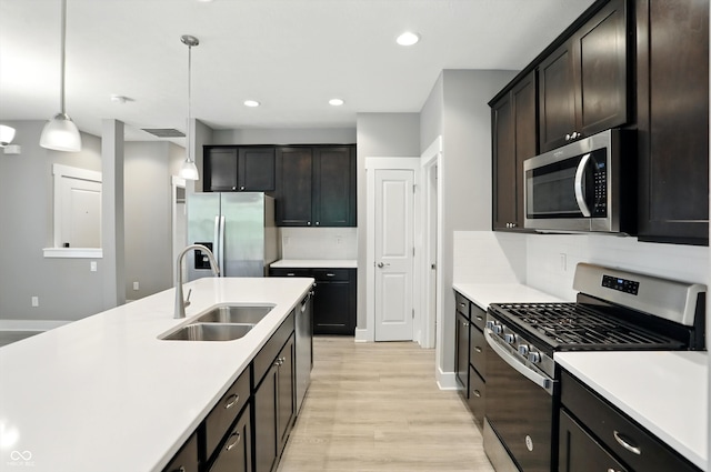 14474 Treasure Creek Ln, Fishers, IN 46038 - kitchen featuring appliances with stainless steel finishes, light wood-style floors, light countertops, pendant lighting, and recessed lighting