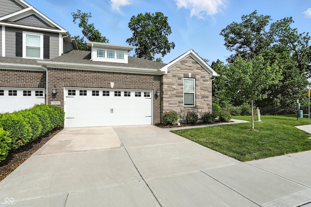 14474 Treasure Creek Ln, Fishers, IN 46038 - view of front of property with a front lawn, concrete driveway, an attached garage, a shingled roof, and stone siding