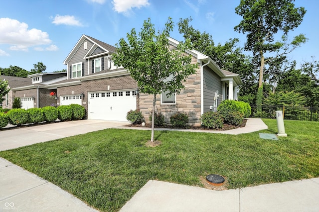 14474 Treasure Creek Ln, Fishers, IN 46038 - view of front of property featuring a garage, concrete driveway, a front yard, and stone siding