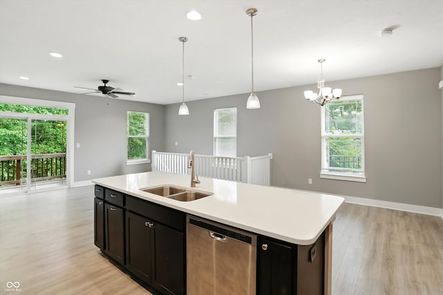 14474 Treasure Creek Ln, Fishers, IN 46038 - kitchen with stainless steel dishwasher, light wood-style flooring, light countertops, open floor plan, and a center island with sink
