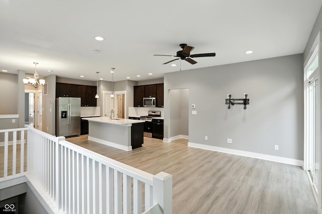 14474 Treasure Creek Ln, Fishers, IN 46038 - kitchen featuring stainless steel appliances, a center island with sink, light countertops, recessed lighting, and ceiling fan