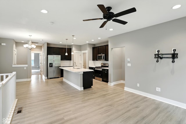 14474 Treasure Creek Ln, Fishers, IN 46038 - kitchen with stainless steel appliances, a chandelier, light wood-type flooring, recessed lighting, and light countertops