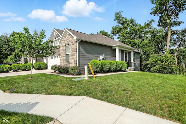 14474 Treasure Creek Ln, Fishers, IN 46038 - view of front of house with stone siding, driveway, an attached garage, and roof with shingles