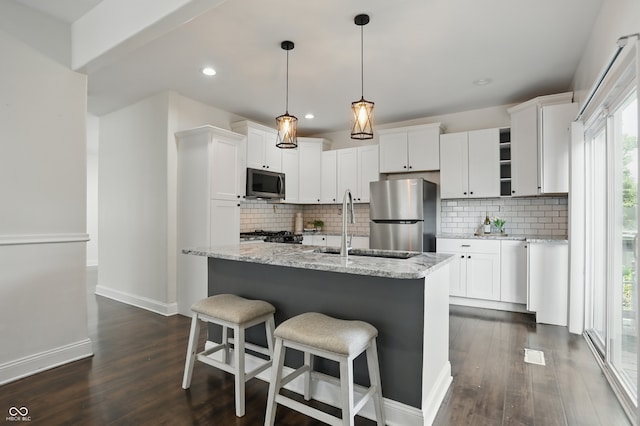3307 N College Ave, Indianapolis, IN 46205 - kitchen with appliances with stainless steel finishes, dark wood-style flooring, backsplash, white cabinetry, and recessed lighting