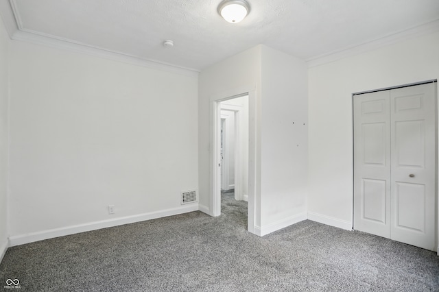 3307 N College Ave, Indianapolis, IN 46205 - unfurnished bedroom featuring carpet floors, crown molding, and a closet