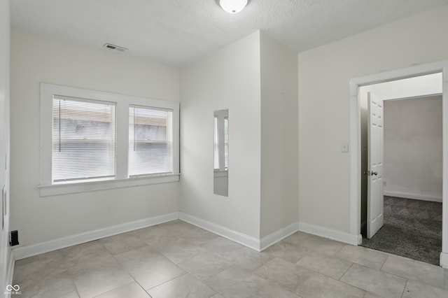 3307 N College Ave, Indianapolis, IN 46205 - unfurnished room featuring a textured ceiling and light tile patterned floors