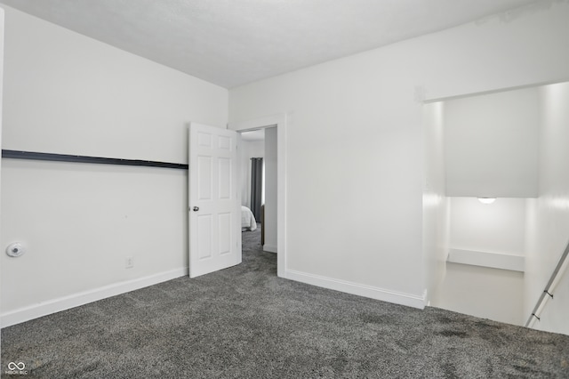 3307 N College Ave, Indianapolis, IN 46205 - unfurnished bedroom with dark colored carpet and baseboards