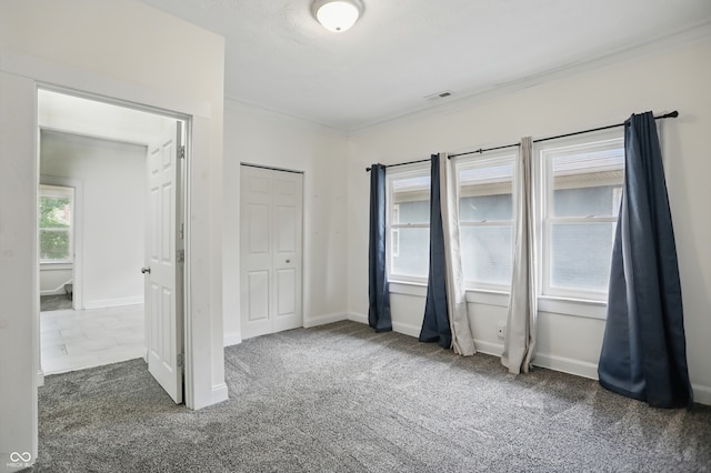 3307 N College Ave, Indianapolis, IN 46205 - unfurnished bedroom featuring carpet floors, ornamental molding, and a closet