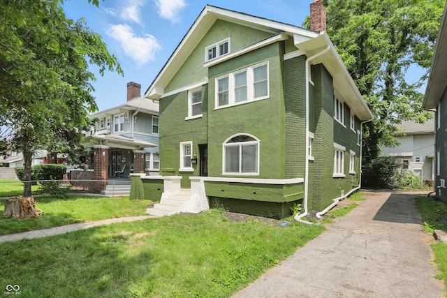 3307 N College Ave, Indianapolis, IN 46205 - view of front of home featuring a chimney, asphalt driveway, and stucco siding