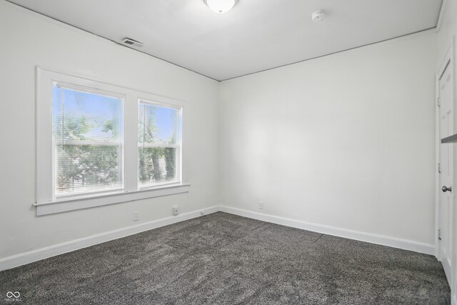 3307 N College Ave, Indianapolis, IN 46205 - empty room featuring dark carpet and a smoke detector