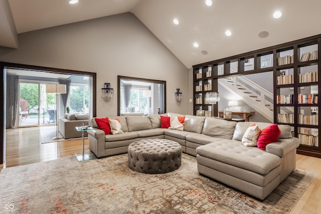 8651 Emerald Ln, Indianapolis, IN 46260 - living area featuring high vaulted ceiling, wood finished floors, stairway, and recessed lighting