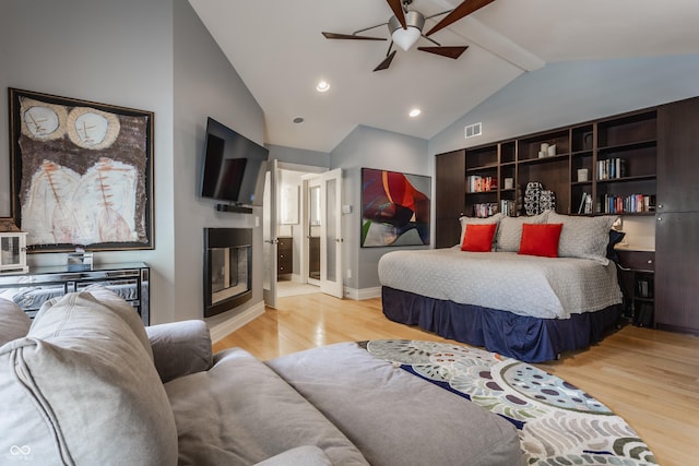 8651 Emerald Ln, Indianapolis, IN 46260 - bedroom with light wood-type flooring, beamed ceiling, a glass covered fireplace, high vaulted ceiling, and recessed lighting
