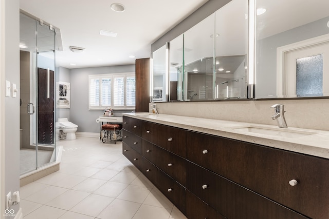 8651 Emerald Ln, Indianapolis, IN 46260 - full bath featuring double vanity, a shower stall, tile patterned floors, and recessed lighting