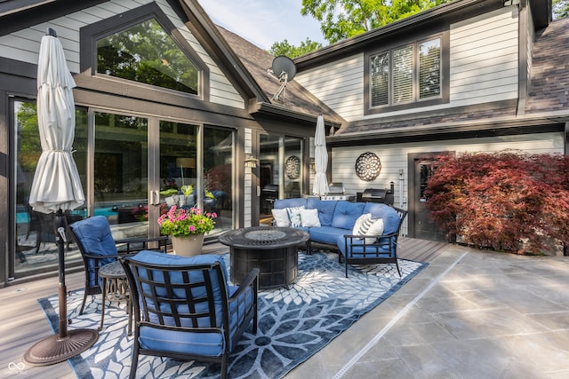 8651 Emerald Ln, Indianapolis, IN 46260 - wooden terrace featuring an outdoor living space with a fire pit
