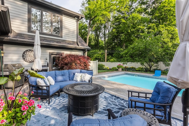 8651 Emerald Ln, Indianapolis, IN 46260 - view of swimming pool featuring a grill, outdoor lounge area, a fenced backyard, and a patio area