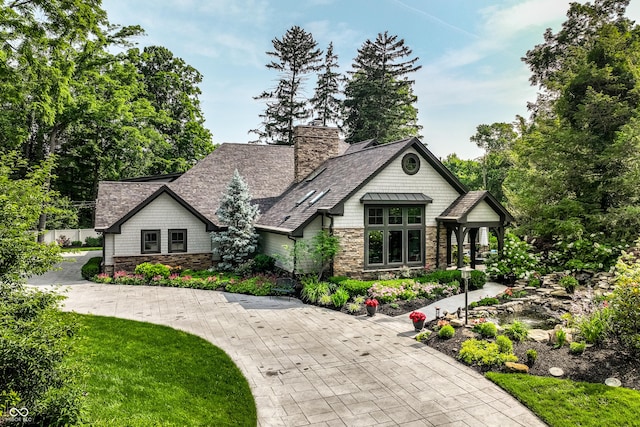 8651 Emerald Ln, Indianapolis, IN 46260 - view of front of house with stone siding and a chimney