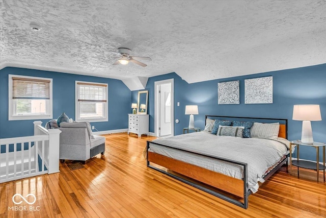 4732 N Kenwood Ave, Indianapolis, IN 46208 - bedroom featuring vaulted ceiling, wood finished floors, a ceiling fan, and a textured ceiling