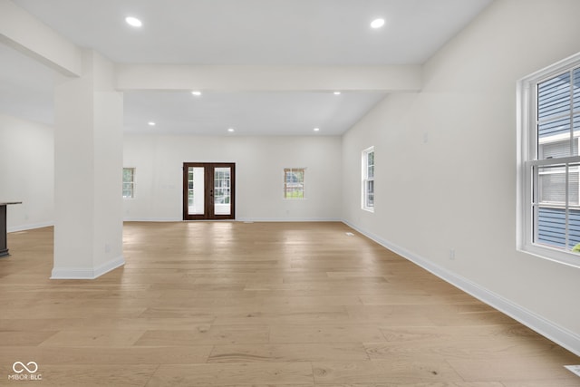 2031 Central Ave, Indianapolis, IN 46202 - unfurnished living room featuring plenty of natural light, light wood-type flooring, recessed lighting, and french doors