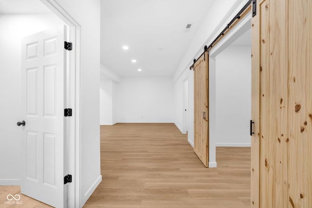 2031 Central Ave, Indianapolis, IN 46202 - hallway with a barn door, recessed lighting, and light wood-style flooring