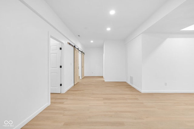 2031 Central Ave, Indianapolis, IN 46202 - spare room with a barn door, recessed lighting, and light wood-type flooring