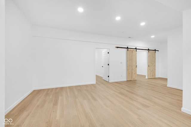 2031 Central Ave, Indianapolis, IN 46202 - unfurnished room featuring light wood-type flooring, recessed lighting, and a barn door