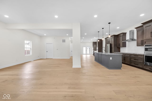 2031 Central Ave, Indianapolis, IN 46202 - kitchen with wall chimney range hood, open floor plan, healthy amount of natural light, and recessed lighting
