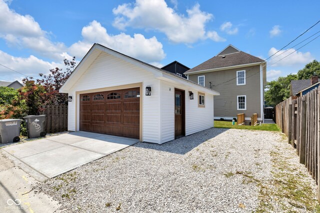 2031 Central Ave, Indianapolis, IN 46202 - view of front of house with an outbuilding, a detached garage, and driveway
