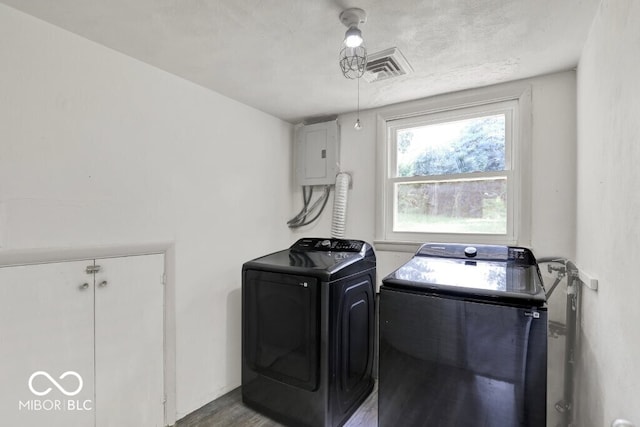 3630 E Morningside Dr, Bloomington, IN 47408 - washroom featuring electric panel, washing machine and clothes dryer, wood finished floors, and a textured ceiling