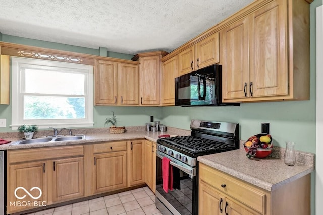 3630 E Morningside Dr, Bloomington, IN 47408 - kitchen with stainless steel gas stove, black microwave, light countertops, and light tile patterned floors