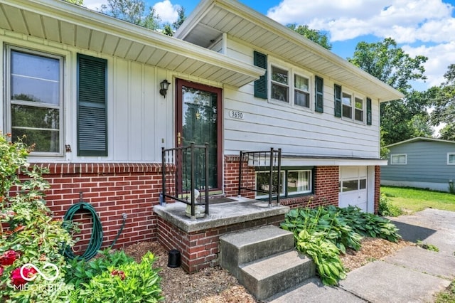 3630 E Morningside Dr, Bloomington, IN 47408 - property entrance with brick siding and an attached garage