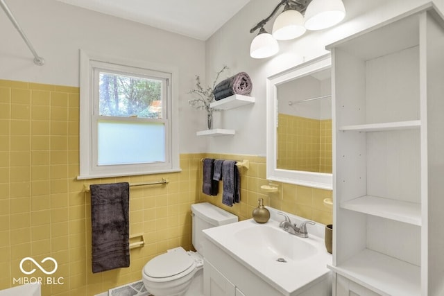 3630 E Morningside Dr, Bloomington, IN 47408 - bathroom with a shower, tile walls, vanity, and wainscoting
