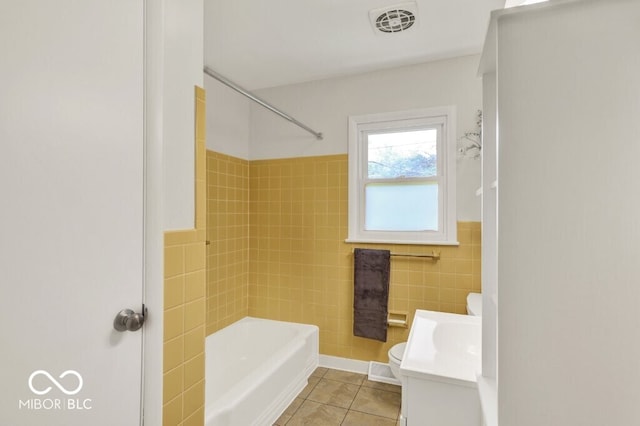 3630 E Morningside Dr, Bloomington, IN 47408 - full bath with tile walls, tile patterned floors, vanity, shower / washtub combination, and a wainscoted wall