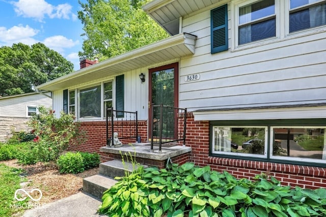3630 E Morningside Dr, Bloomington, IN 47408 - view of exterior entry with brick siding and a chimney