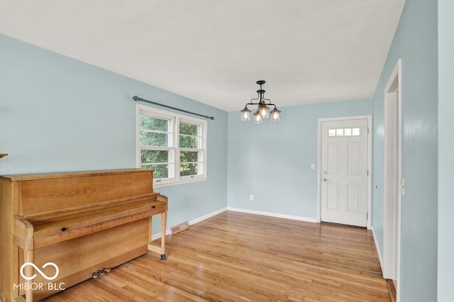 3630 E Morningside Dr, Bloomington, IN 47408 - entryway with light wood-type flooring and a chandelier