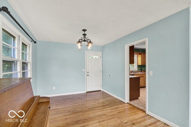 3630 E Morningside Dr, Bloomington, IN 47408 - unfurnished dining area with light wood-type flooring and a chandelier