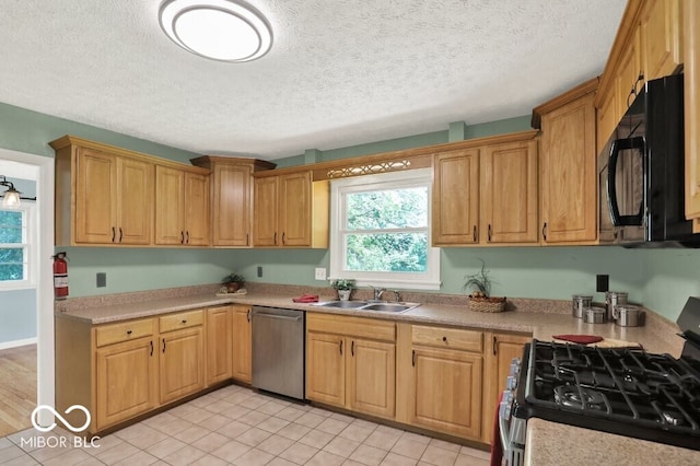 3630 E Morningside Dr, Bloomington, IN 47408 - kitchen with stainless steel appliances, a textured ceiling, light countertops, and light tile patterned floors