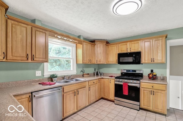 3630 E Morningside Dr, Bloomington, IN 47408 - kitchen featuring appliances with stainless steel finishes, light countertops, light tile patterned floors, and a textured ceiling