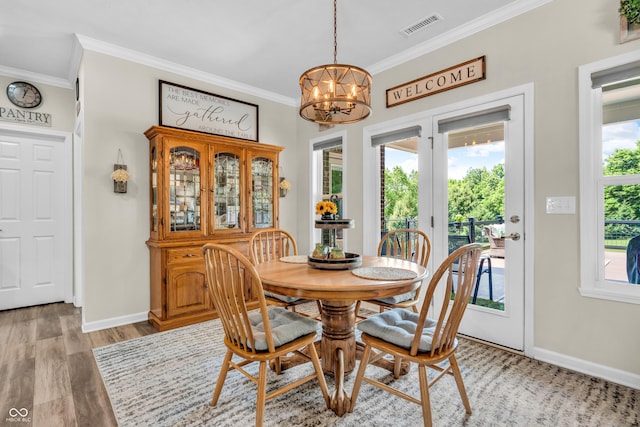 9231 E Poynter Dr, Morgantown, IN 46160 - dining space featuring a chandelier, crown molding, healthy amount of natural light, and light wood finished floors