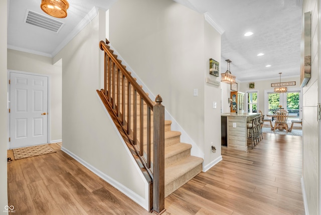 9231 E Poynter Dr, Morgantown, IN 46160 - stairway with crown molding, wood finished floors, recessed lighting, and a chandelier