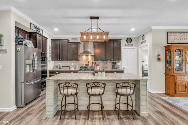 9231 E Poynter Dr, Morgantown, IN 46160 - kitchen with appliances with stainless steel finishes, wall chimney exhaust hood, light wood-style floors, dark brown cabinetry, and recessed lighting
