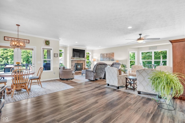 9231 E Poynter Dr, Morgantown, IN 46160 - living area featuring healthy amount of natural light, wood finished floors, ceiling fan, a fireplace, and recessed lighting