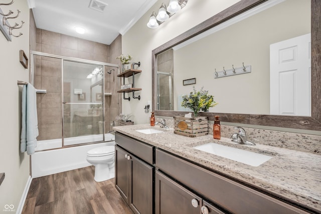 9231 E Poynter Dr, Morgantown, IN 46160 - bathroom with double vanity, wood finished floors, shower / bath combination with glass door, and crown molding