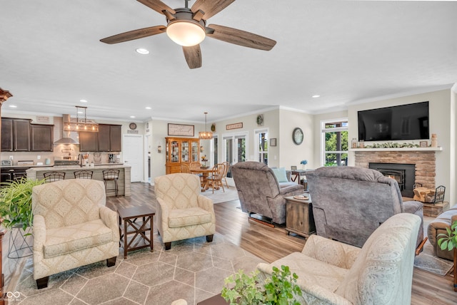 9231 E Poynter Dr, Morgantown, IN 46160 - living area with light wood finished floors, a fireplace, recessed lighting, crown molding, and ceiling fan