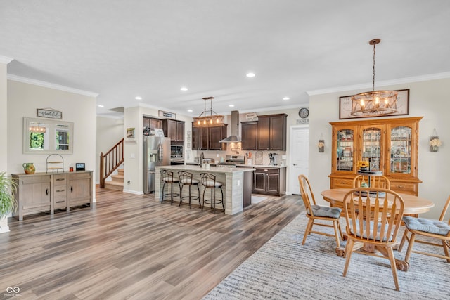 9231 E Poynter Dr, Morgantown, IN 46160 - dining room featuring a chandelier, crown molding, light wood finished floors, recessed lighting, and stairs