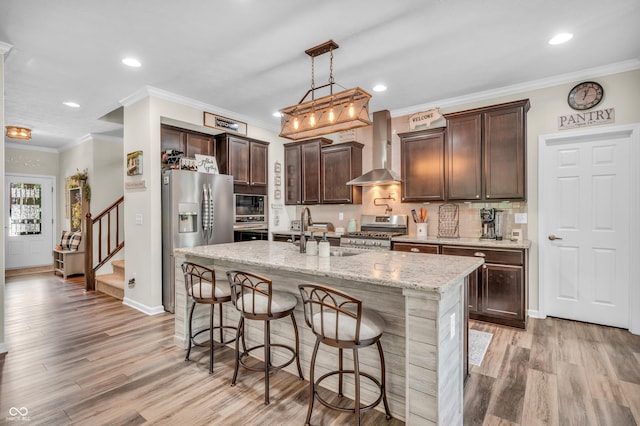 9231 E Poynter Dr, Morgantown, IN 46160 - kitchen with wall chimney exhaust hood, stainless steel appliances, dark brown cabinets, light wood-style floors, and recessed lighting