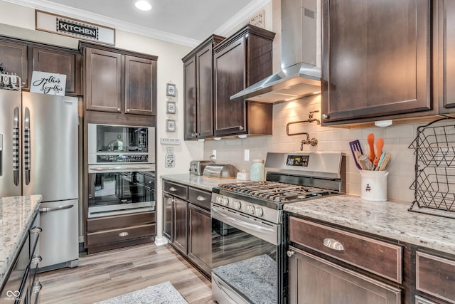 9231 E Poynter Dr, Morgantown, IN 46160 - kitchen featuring wall chimney range hood, appliances with stainless steel finishes, crown molding, dark brown cabinetry, and light stone counters